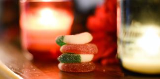 Cbd gummies stacked up next to candles