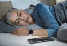 Sleep Apps - Tech-savvy Senior Woman Sleeping in Bed