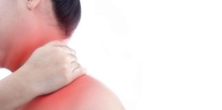 Young woman with neck pain and at white background