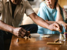 Man in white shirt and woman in blue shirt holding hands