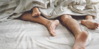 Close up couple feet having sex in bed