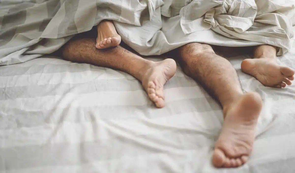 Close up couple feet having sex in bed
