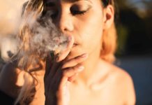 Woman smoking cannabis shot up close