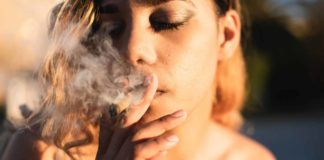 Woman smoking cannabis shot up close