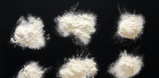 Sprinkled wheat flour splash spots on black background