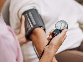 Blood pressure, hypertension and nurse with patient to check diabetes, healthcare consulting and se