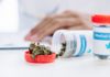 selective focus of bottle with medical cannabis on white table
