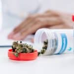 selective focus of bottle with medical cannabis on white table