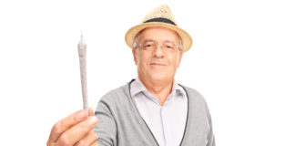 mature man holding medicinal marijuana