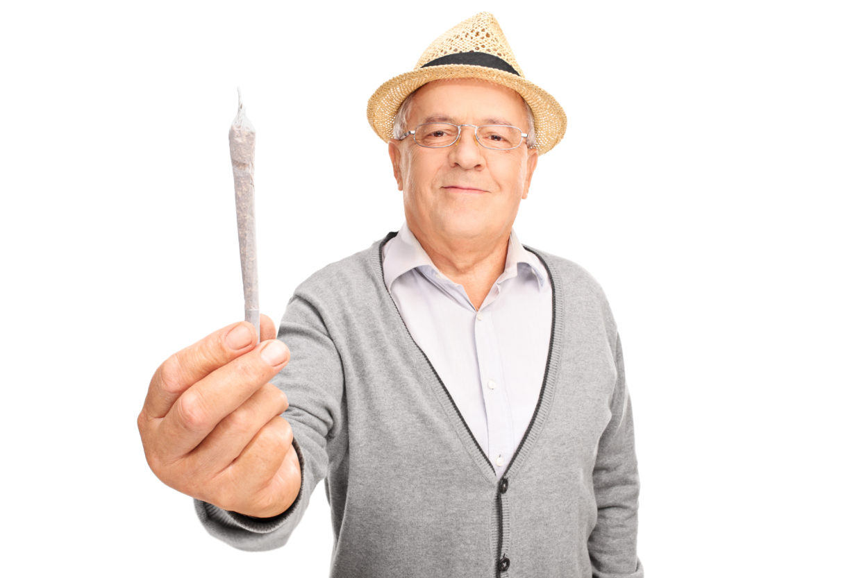mature man holding medicinal marijuana