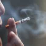 Closeup shot of a Chinese female smoking a cigarette
