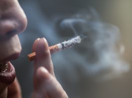 Closeup shot of a Chinese female smoking a cigarette