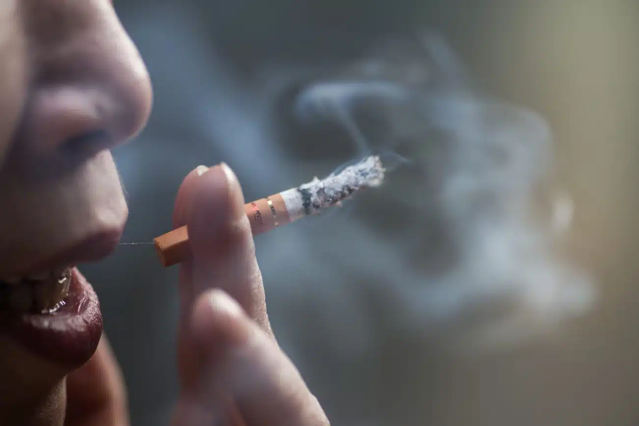 Closeup shot of a Chinese female smoking a cigarette