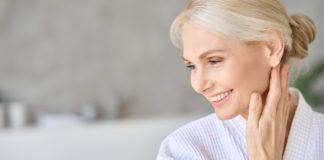 Happy smiling mid age woman looking away. Copy space. Skin care concept.
