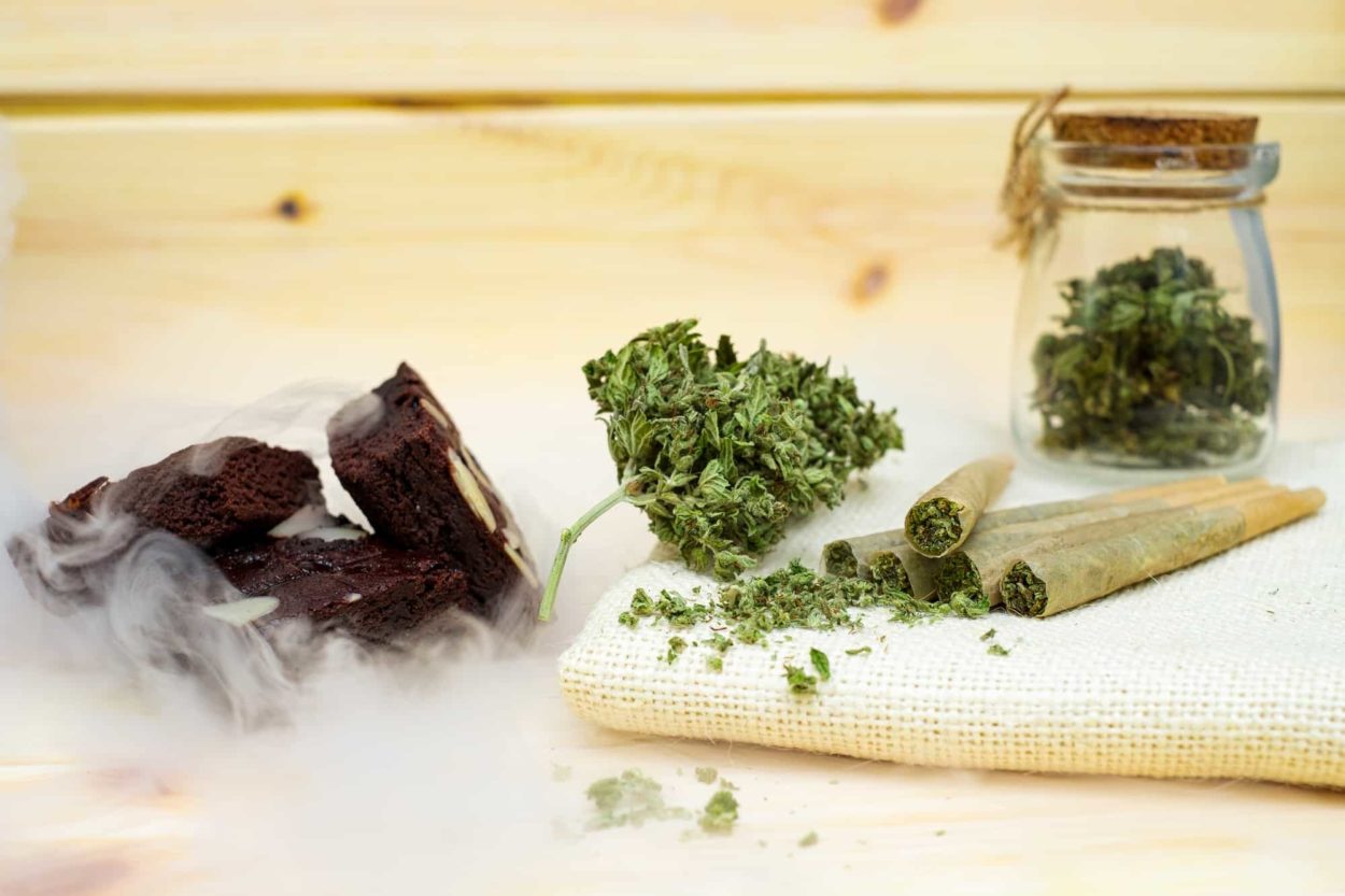 Pre-Roll cannabis joints and cake brownies with cannabis buds