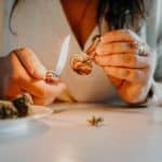 a-woman-lighting-a-cigarette-on-a-plate-of-food-stockpack-unsplash