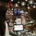 Budtender is sharing a POS tablet with product information with consumers. Hip to hip interaction.