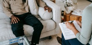 Crop unrecognizable black man sharing complains with female psychologist