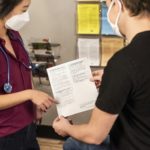 In this 2020 photograph, captured inside a clinical setting, a health care provider and patient, consult on influenza vaccine options. The best way to prevent seasonal flu illness, is to get vaccinated every year. Centers for Disease Control and Prevention (CDC) recommends everyone 6-months of age and older get a flu vaccine every season. There are many vaccine options to choose from, but the most important thing, is for all people 6-months and older, get an influenza vaccine every year.