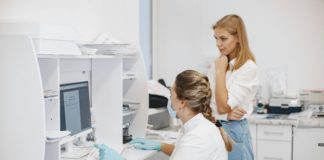 Medical workers looking a computer screen