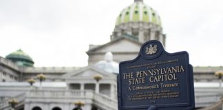 Pennsylvania State Capitol signage wtih capitol building in background