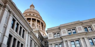 The Texas State Capitol set against a clear blue sky.