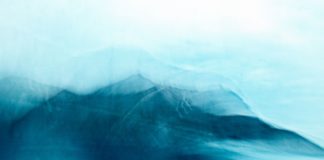 A blue and white photograph of a mountain range