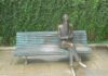 Valle-Inclán y sus primeras alusiones al cannabis Escultura de bronce de un hombre barbado con gafas, sentado con las piernas cruzadas en un banco