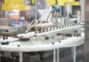 Massachusetts suspende la fabricación de cannabis de MRM Industries Una línea automatizada transporta pequeños frascos de vidrio ámbar en una instalación de fabricación